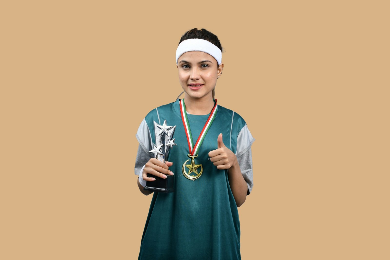 Young athlete holding trophies and medals.